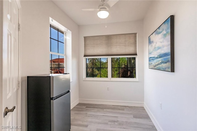 kitchen featuring ceiling fan, stainless steel fridge, and light hardwood / wood-style flooring