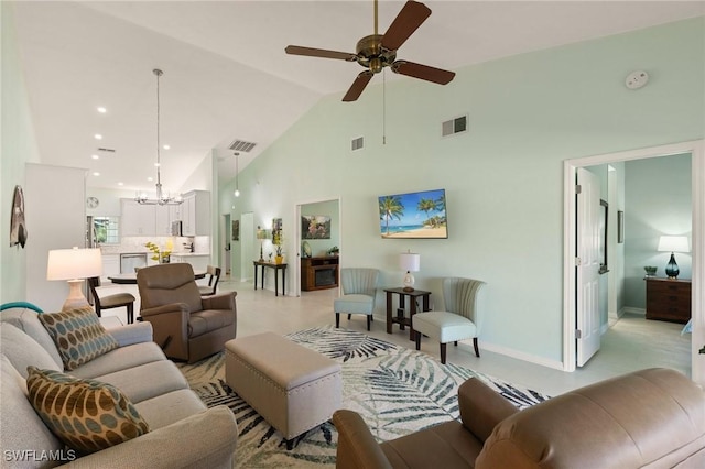 living room with high vaulted ceiling and ceiling fan with notable chandelier