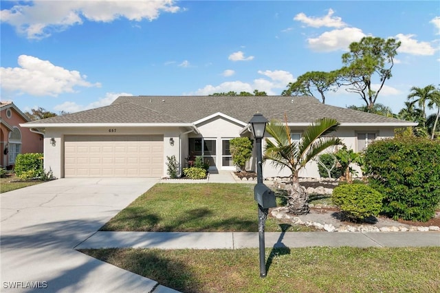 view of front of house with a front yard and a garage