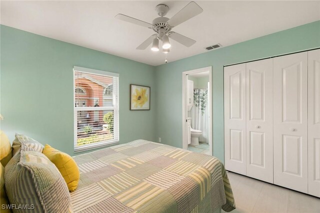 bedroom featuring ensuite bath, ceiling fan, and a closet