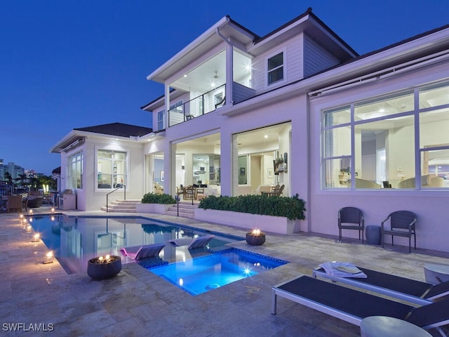 view of swimming pool featuring an in ground hot tub and a patio area