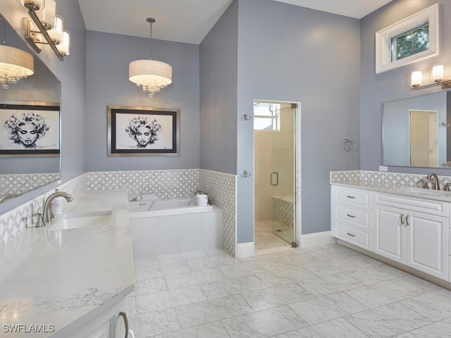 bathroom with vanity and independent shower and bath