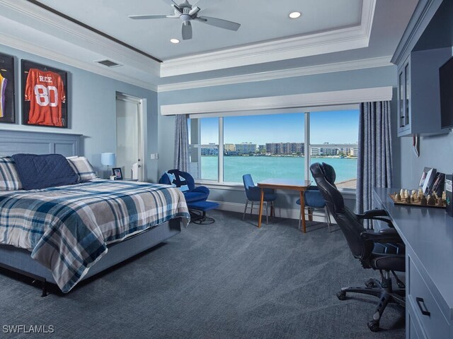 bedroom featuring a water view, ceiling fan, ornamental molding, and a tray ceiling