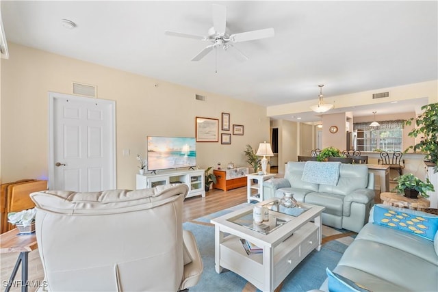 living room featuring hardwood / wood-style floors and ceiling fan