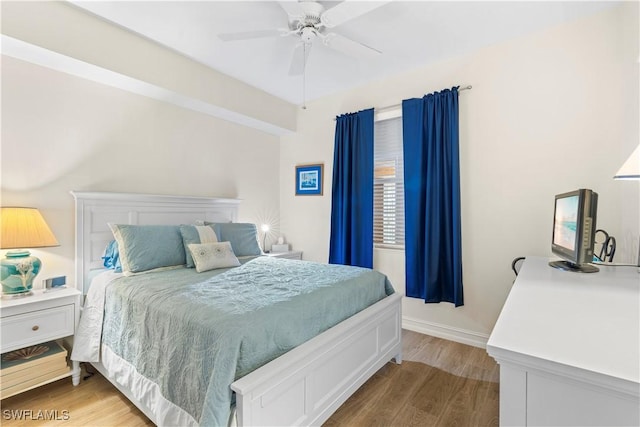 bedroom with hardwood / wood-style floors and ceiling fan