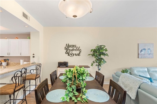 dining room with light hardwood / wood-style flooring