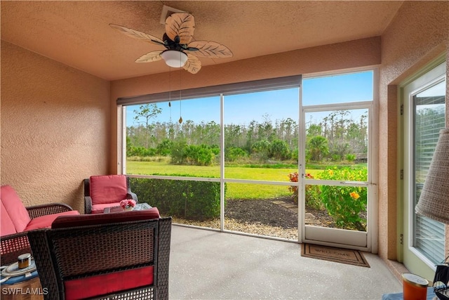 sunroom / solarium with ceiling fan and a healthy amount of sunlight