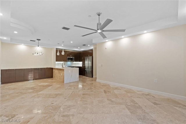 kitchen featuring dark brown cabinets, stainless steel appliances, hanging light fixtures, and ceiling fan