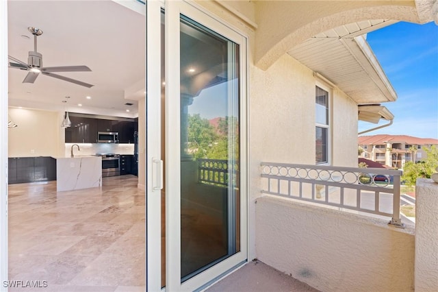 balcony with ceiling fan and sink