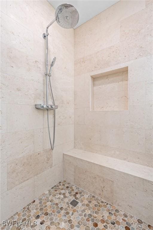 bathroom featuring tiled shower