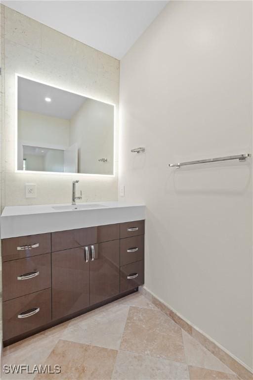 bathroom with vanity and lofted ceiling