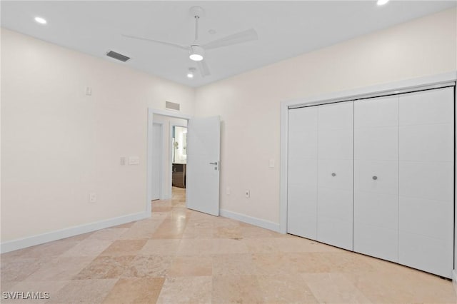 unfurnished bedroom with ceiling fan and a closet