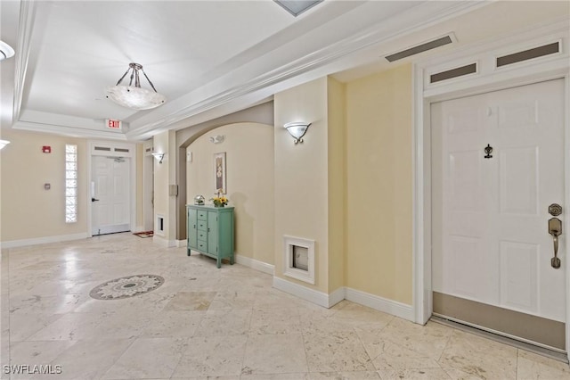 foyer entrance featuring a tray ceiling