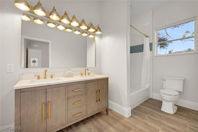 full bathroom with hardwood / wood-style flooring, shower / bath combination with curtain, toilet, and vanity