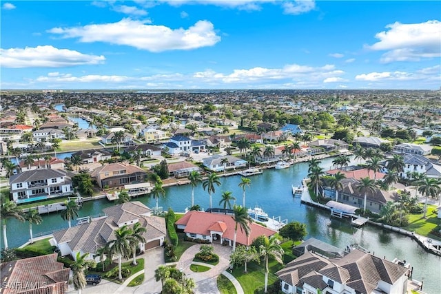 birds eye view of property with a water view and a residential view