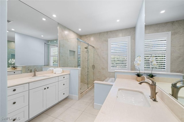 bathroom featuring vanity, a healthy amount of sunlight, and walk in shower