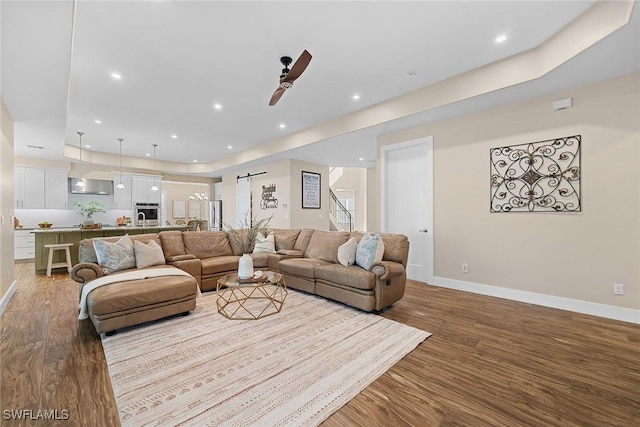 living room with ceiling fan and light hardwood / wood-style floors