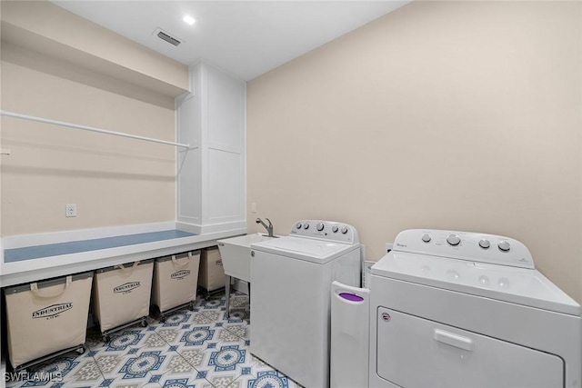 washroom featuring sink and independent washer and dryer