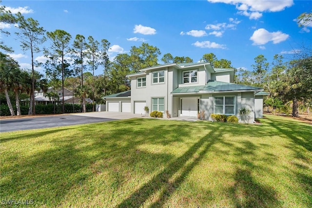 view of front of property with a front yard and a garage