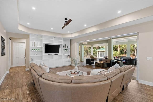 living room with ceiling fan and wood-type flooring