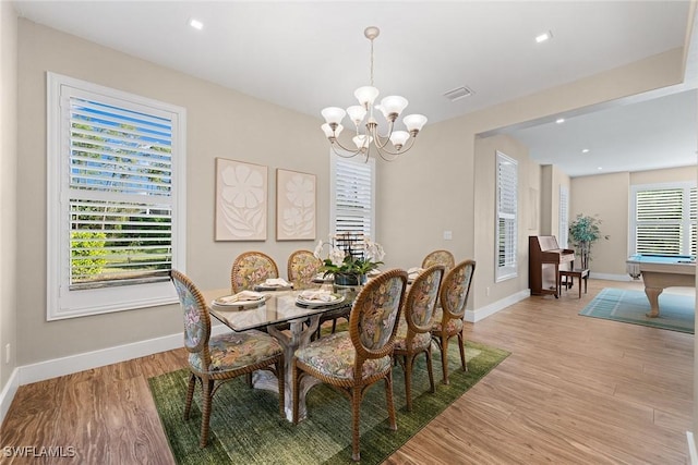 dining area featuring a chandelier, light hardwood / wood-style flooring, and pool table