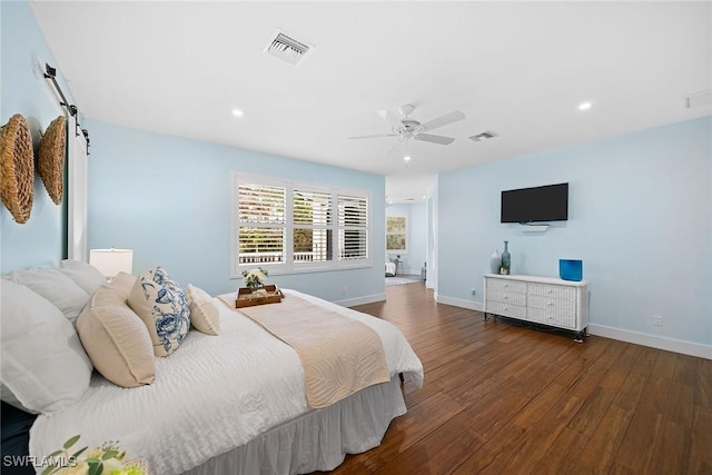 bedroom with dark hardwood / wood-style flooring and ceiling fan