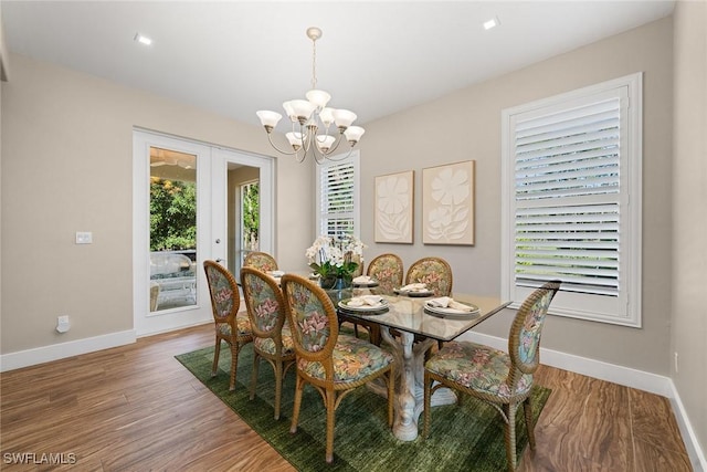 dining room featuring french doors, hardwood / wood-style flooring, and a notable chandelier