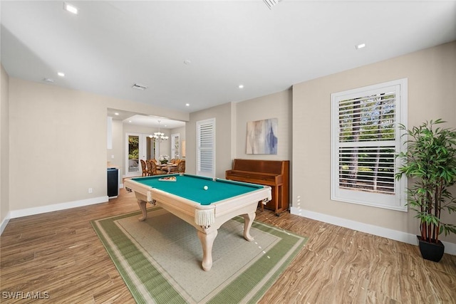 rec room featuring a chandelier and hardwood / wood-style floors