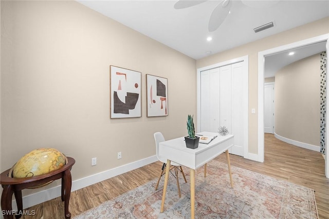 office with ceiling fan and light hardwood / wood-style floors