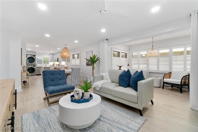 living room featuring a chandelier and light wood-type flooring