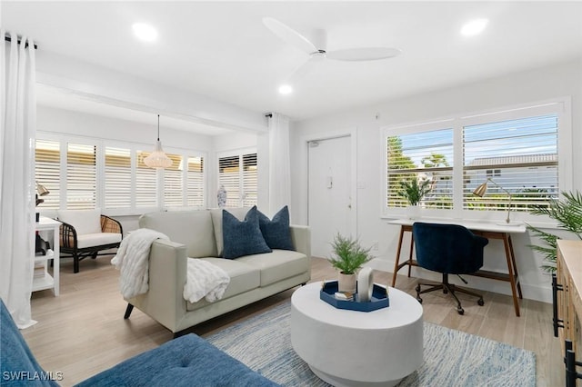 living room featuring light hardwood / wood-style flooring and ceiling fan