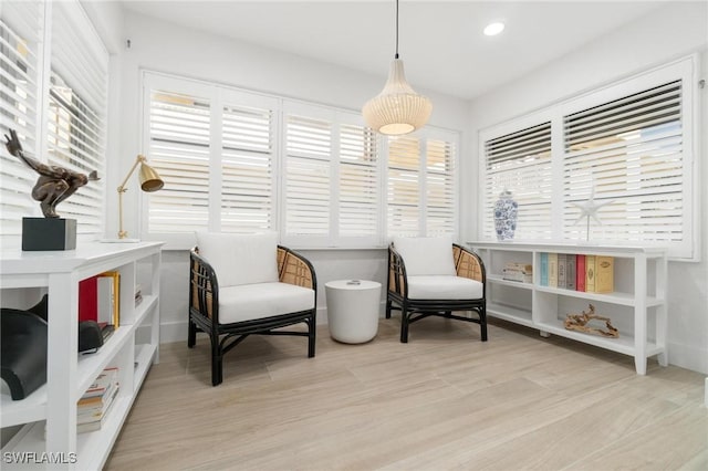 living area with recessed lighting and light wood finished floors