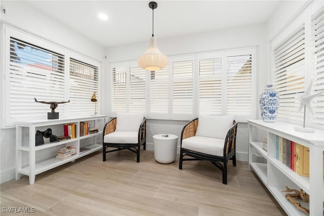 sitting room featuring light wood finished floors, recessed lighting, and baseboards