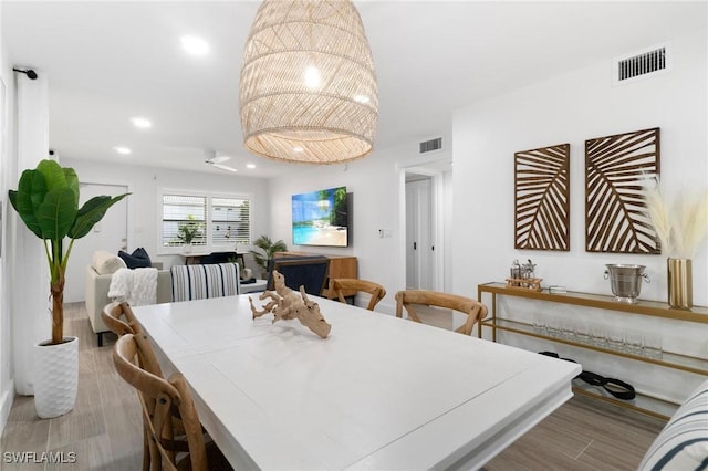 dining space with light wood-style floors, visible vents, and recessed lighting