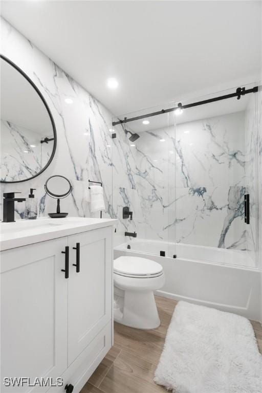 full bathroom featuring shower / bathing tub combination, vanity, hardwood / wood-style flooring, and toilet