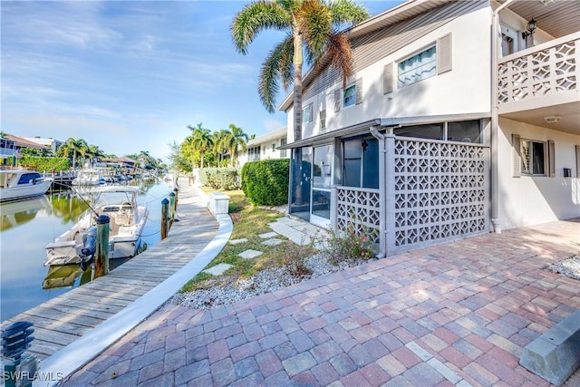 exterior space with a boat dock and a water view