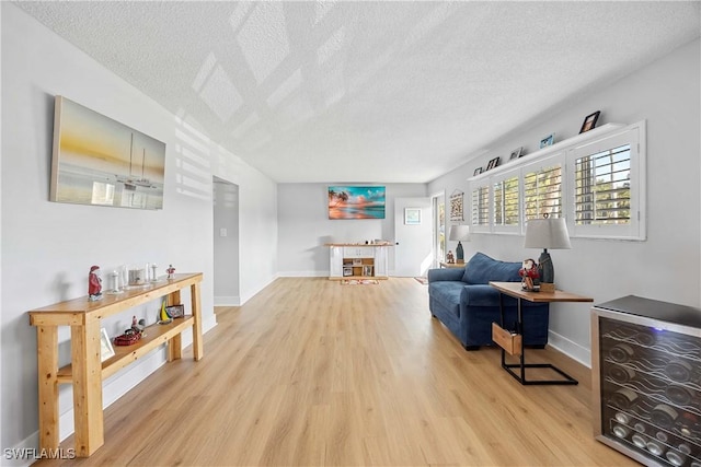 living room featuring a textured ceiling and light hardwood / wood-style floors