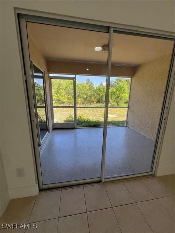 entryway with light tile patterned floors