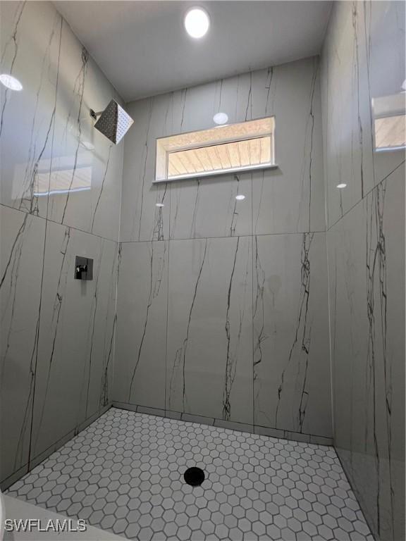 bathroom with a tile shower