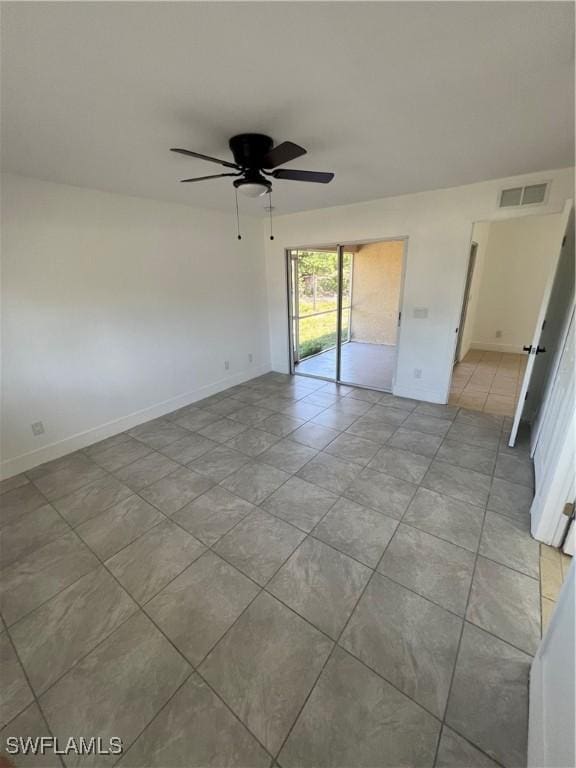 empty room featuring ceiling fan and light tile patterned floors