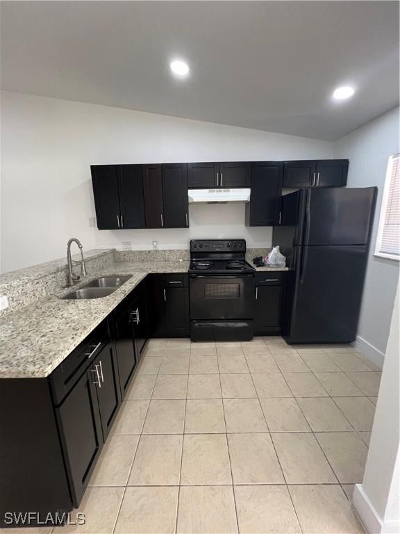 kitchen with light tile patterned flooring, sink, vaulted ceiling, and black appliances