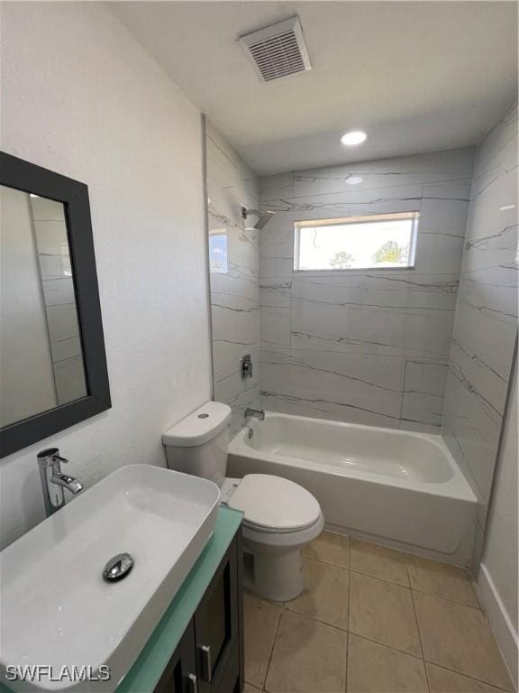 full bathroom with tile patterned floors, tiled shower / bath combo, toilet, and vanity