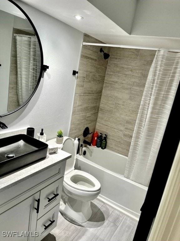 full bathroom with shower / bath combination with curtain, vanity, and toilet