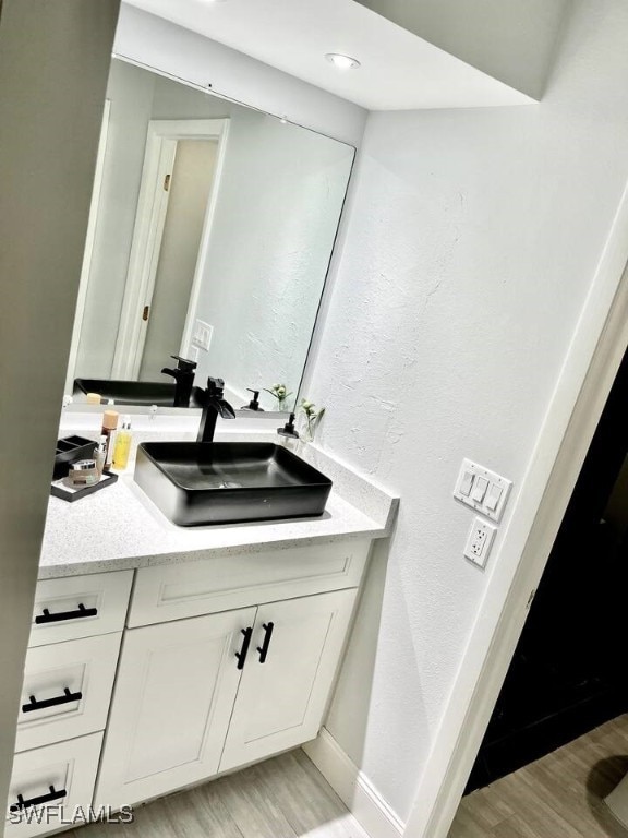 bathroom featuring vanity and hardwood / wood-style flooring