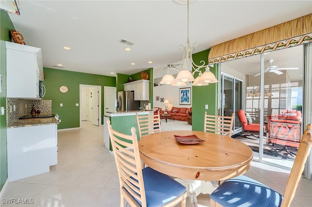 dining space with ceiling fan and light tile patterned floors