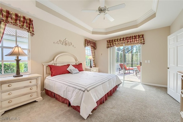 carpeted bedroom with a raised ceiling, access to exterior, ceiling fan, and crown molding