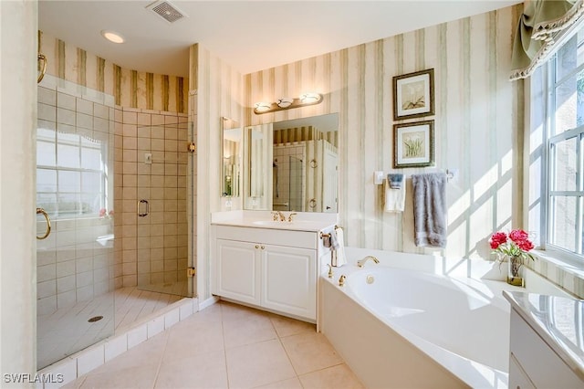 bathroom with tile patterned flooring, vanity, and separate shower and tub