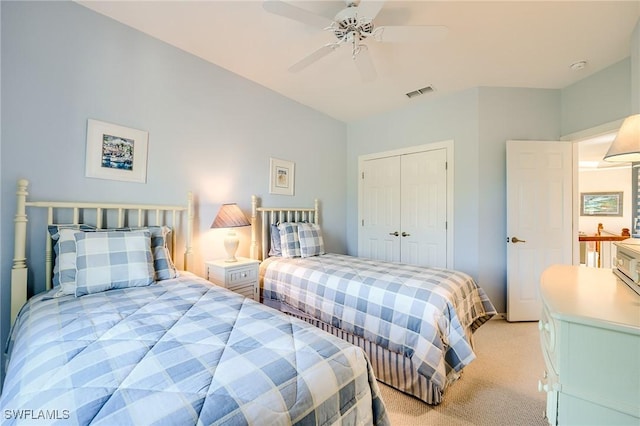 carpeted bedroom with a closet and ceiling fan