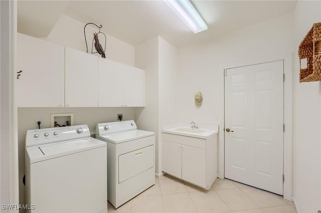 clothes washing area featuring cabinets, separate washer and dryer, sink, and light tile patterned floors