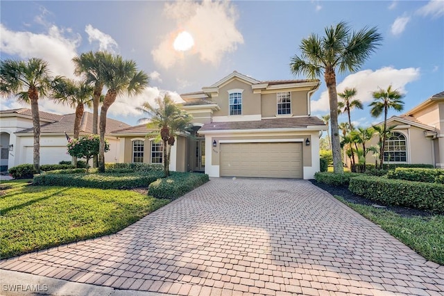 view of property with a front yard and a garage